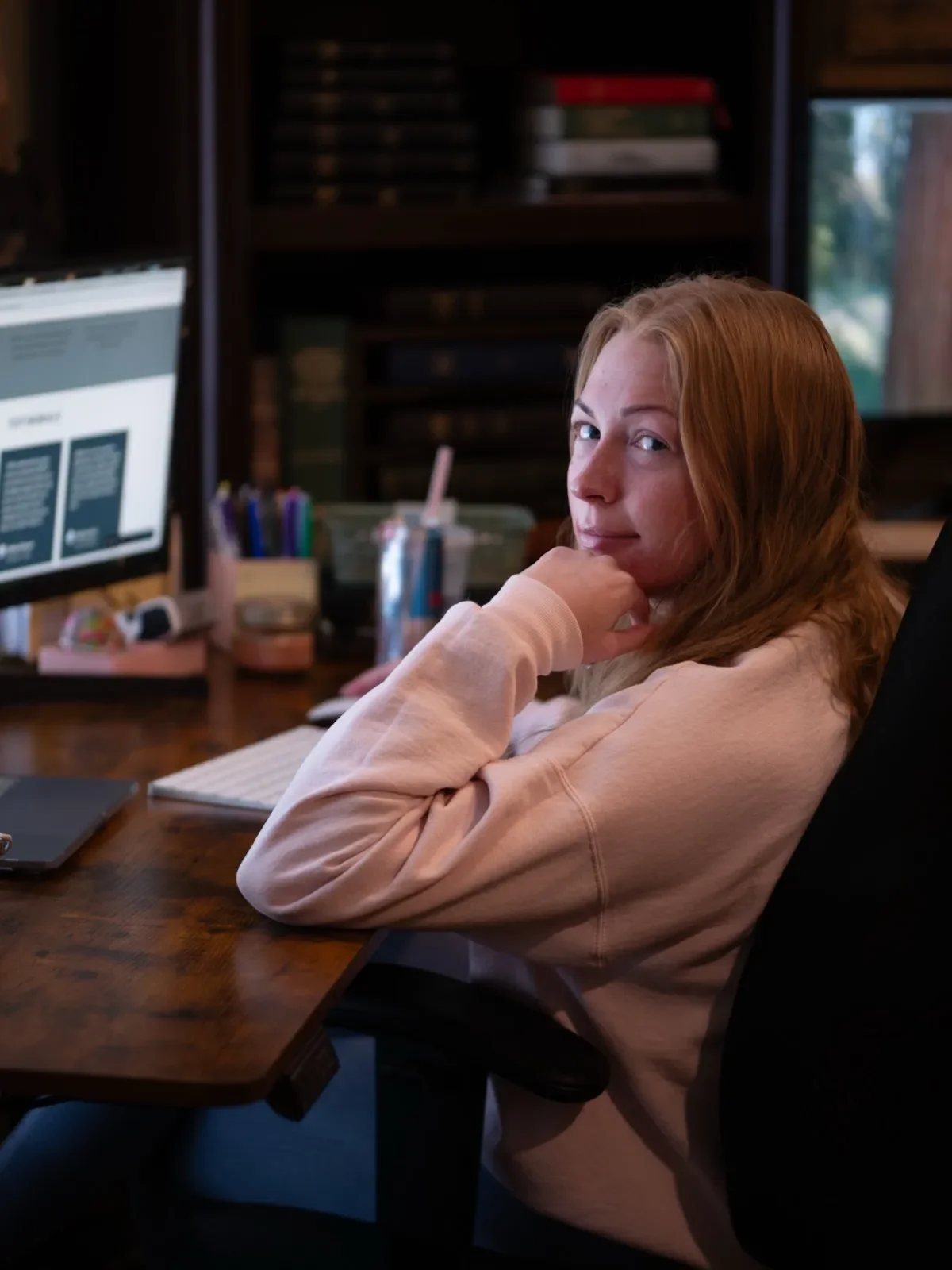 Sarah Sportsman, Sportsman Creative's lead designer, at her desk working on a client's website